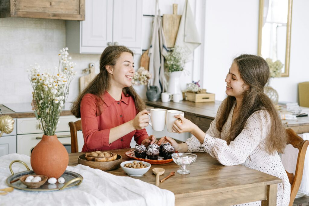 two woman talking at table
