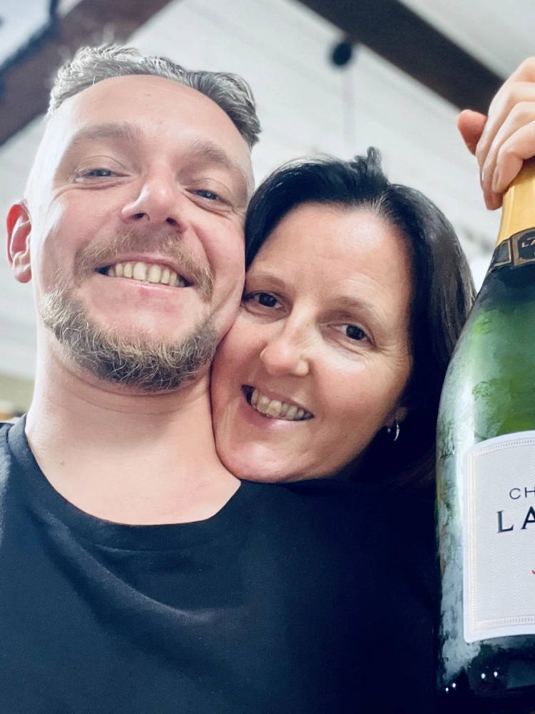 Becky and Joe with champagne